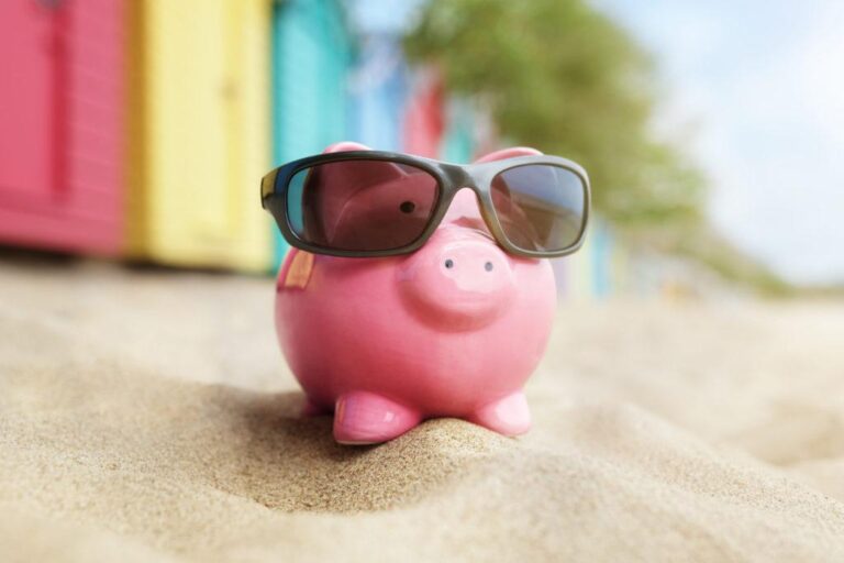 Piggy bank on beach vacation